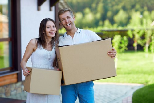 Professional movers handling office assets with care.